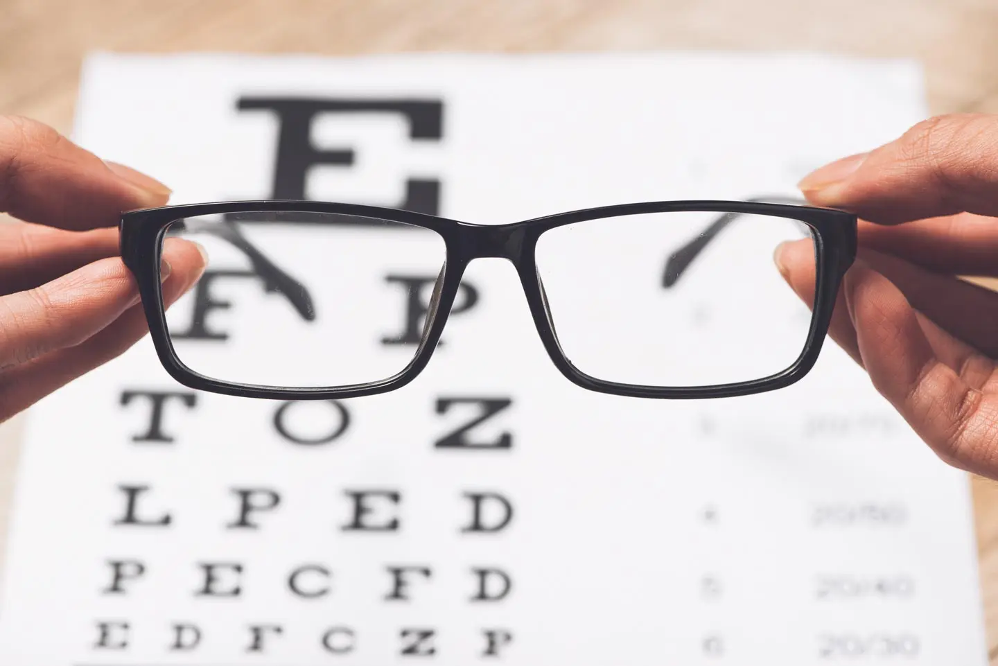 holding spectacles in a self text eye examination