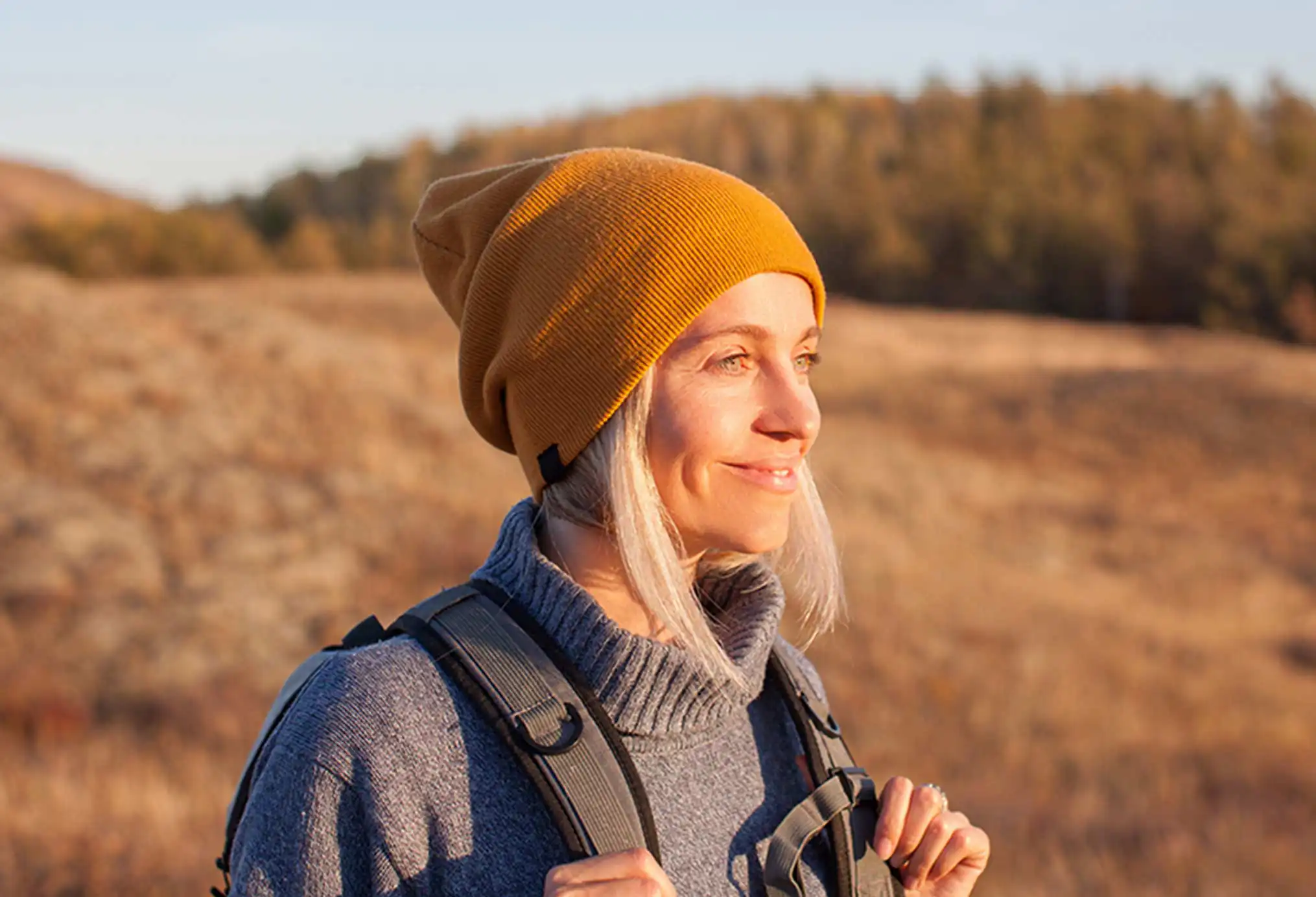 woman hiking and looking toward the sunlight